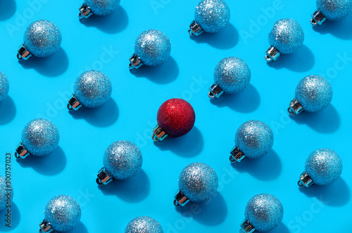 red christmas ball among blue balls. personality concept