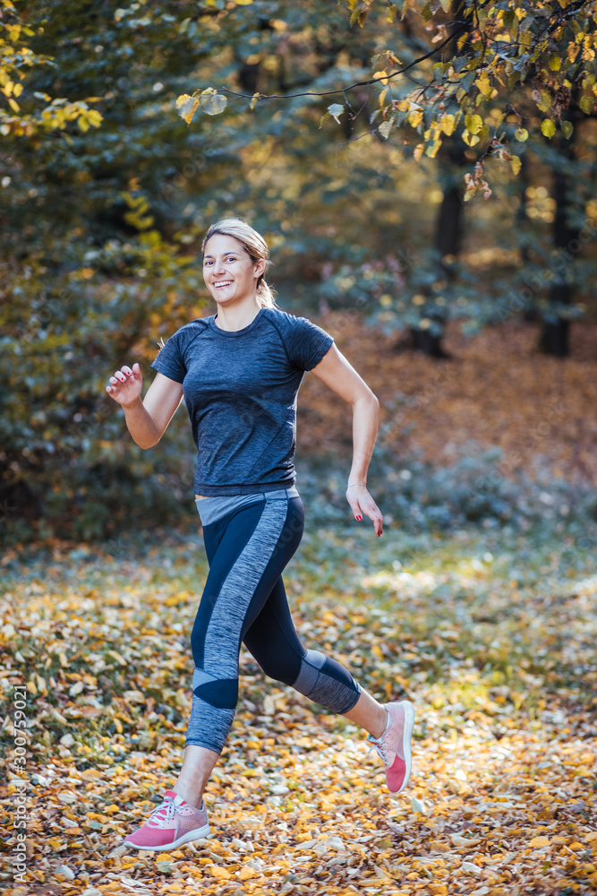 Woman running. Female runner jogging, training for marathon. Fit girl fitness athlete model exercising outdoor. Woman running. Female runner jogging, training for marathon. Fit girl fitness athlete model exercising outdoor.