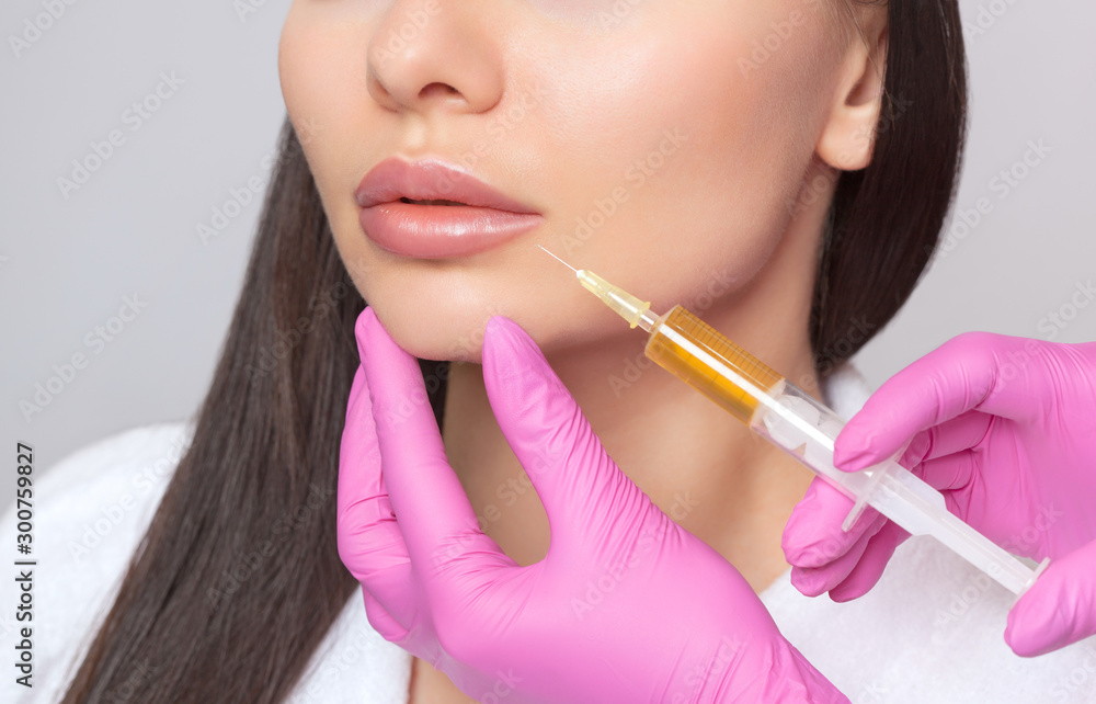 Cosmetologist does prp therapy from wrinkles on the face of a woman in a beauty salon.Cosmetology skin care. Cosmetologist does prp therapy from wrinkles on the face of a woman in a beauty salon.Cosmetology skin care.