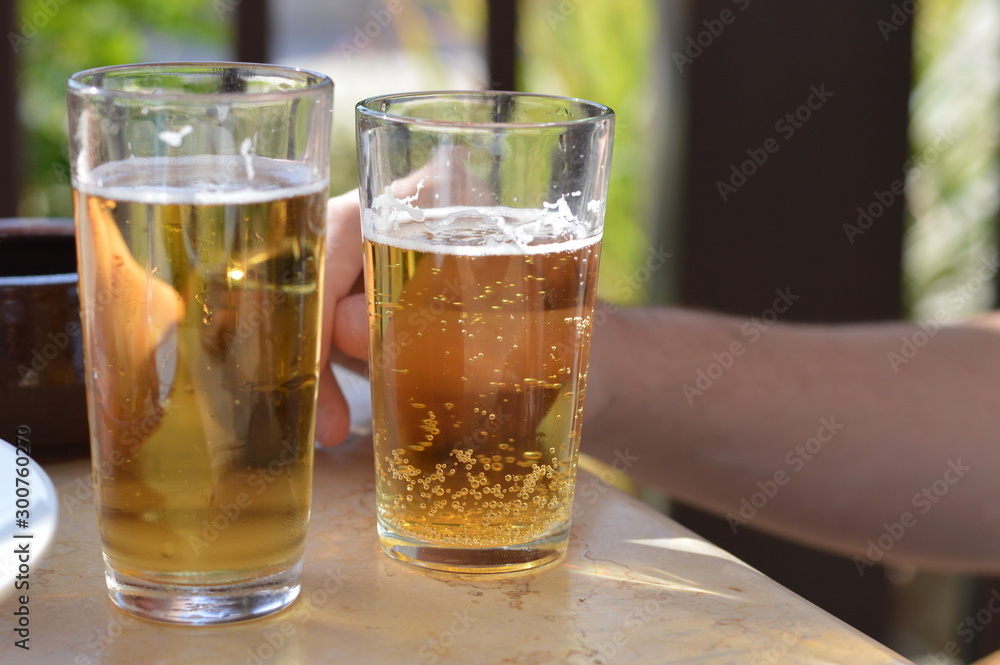 glass of beer on wooden table in a cafe glass of beer on wooden table in a cafe