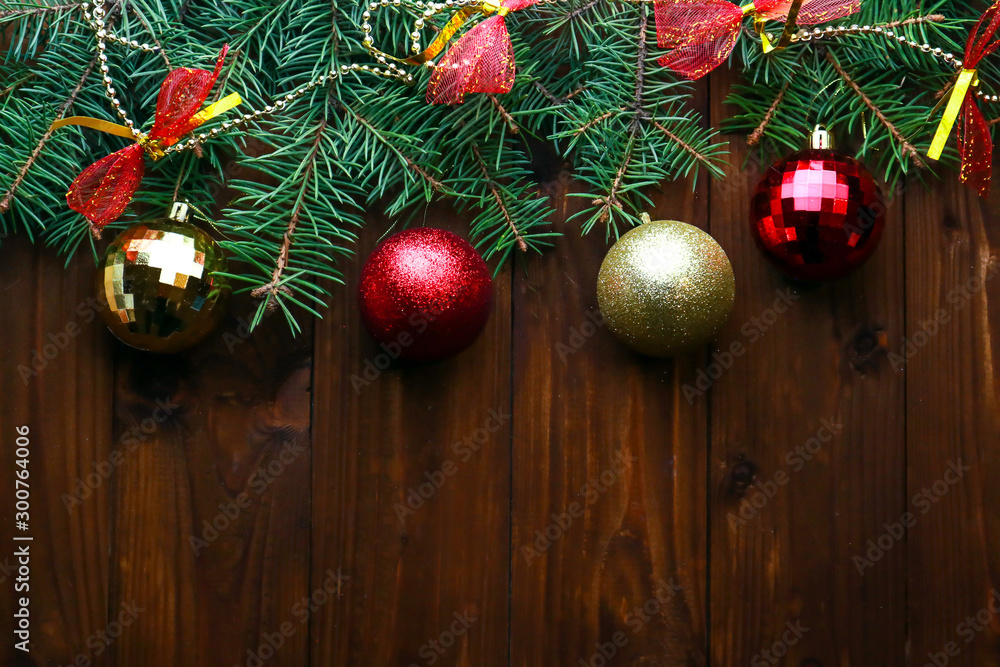 Beautiful Christmas toys with fir tree twigs on wooden background. With space for text Beautiful Christmas toys with fir tree twigs on wooden background. With space for text