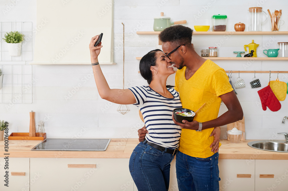 Multiethnic couple breakfasting together in the kitchen Multiethnic couple breakfasting together in the kitchen