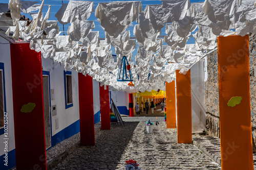 Street fully decorated with multicolored paper in Redondo village, Alentejo region, Portugal.