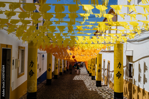Street fully decorated with multicolored paper in Redondo village, Alentejo region, Portugal.