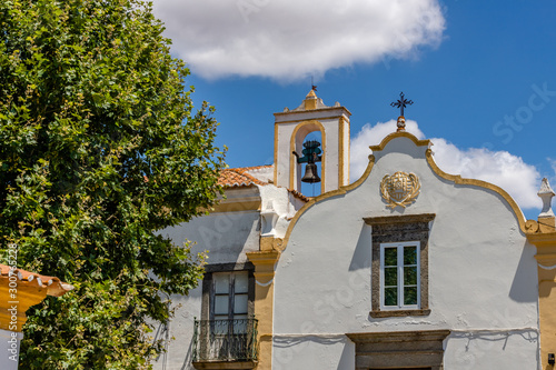 Houses in front of the walls and church the village of Redondo, Alentejo region, Portugal.