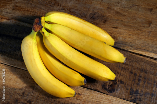 bunch of bananas on wooden background