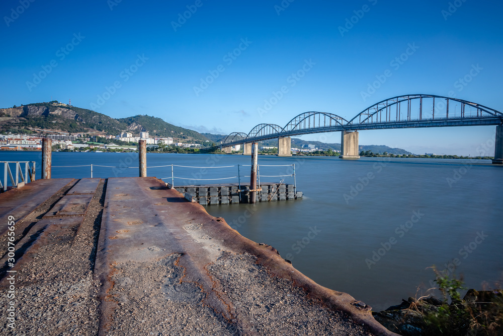 Long exposure landscape image of bridge Marechal Carmona on river Tejo in Vila Franca Xira, Portugal.