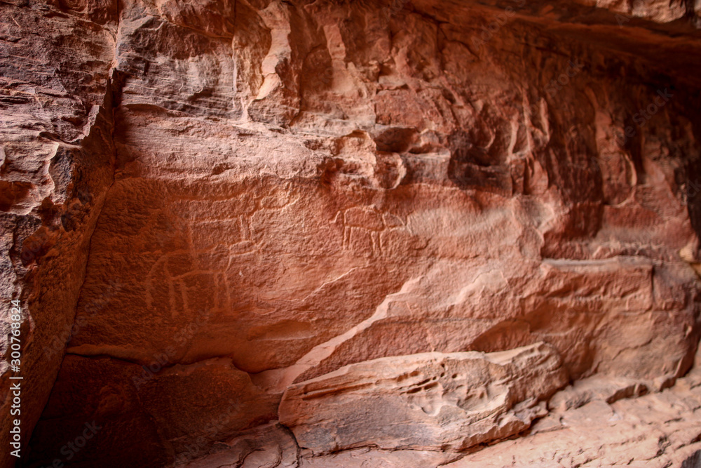 Khazali canyon rock carvings - Petroglyphs and ancient scripts (Thamudic, Nabatean, Arabic) illustrating the 12000 years of human occupation in Wadi Rum, Jordan Khazali canyon rock carvings - Petroglyphs and ancient scripts (Thamudic, Nabatean, Arabic) illustrating the 12000 years of human occupation in Wadi Rum, Jordan
