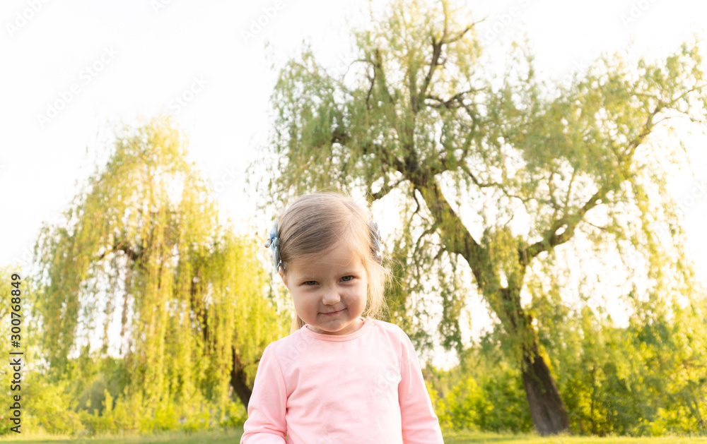 Funny angry face of little cute girl looking in camera Funny angry face of little cute girl looking in camera