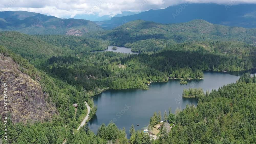 Aerial View at Mountain Lake with Dramatic Clouds in British Columbia, Canada. 4K. Aerial View at Mountain Lake with Dramatic Clouds in British Columbia, Canada. 4K.