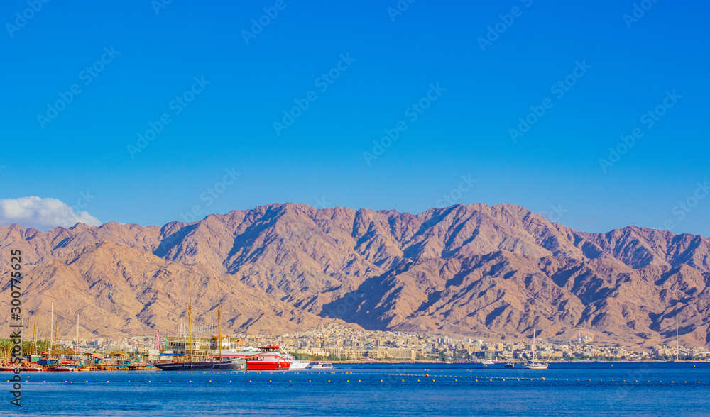 Aqaba Gulf red sea bay Israeli port with ships in Eilat city Middle East desert scenic landscape view Jordanian mountains background