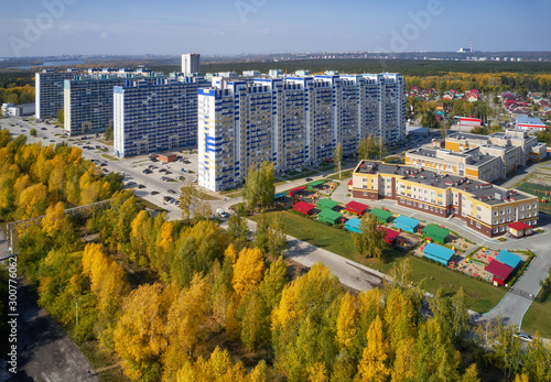 Bird's-eye aerial view on autumn town with modern residential buildings. Novosibirsk, Siberia, Russia.