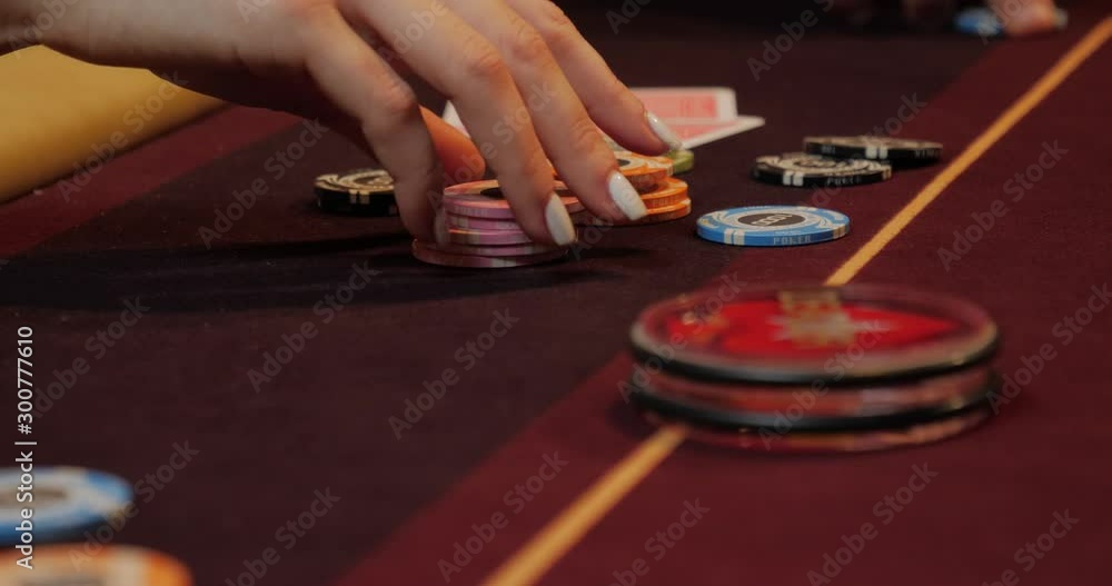 People playing poker, man looking at his cards and pushing chips, all-in People playing poker, man looking at his cards and pushing chips, all-in