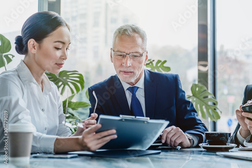 Business people working on business contract papers at office