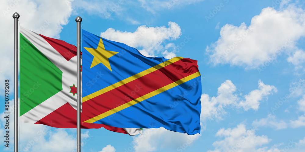 Burundi and Congo flag waving in the wind against white cloudy blue sky together. Diplomacy concept, international relations. Burundi and Congo flag waving in the wind against white cloudy blue sky together. Diplomacy concept, international relations.