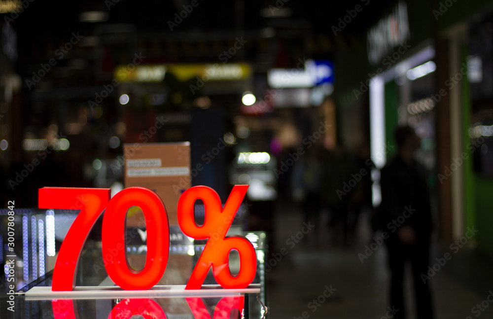Discounts in the shopping center. 70 percent discount. Seasonal sale, black friday. Red label