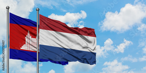 Cambodia and Netherlands flag waving in the wind against white cloudy blue sky together. Diplomacy concept, international relations.
