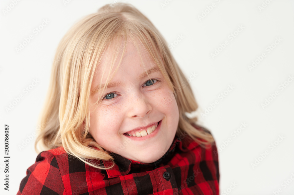 Close up of a smiling young blonde preteen girl on a white studio background Close up of a smiling young blonde preteen girl on a white studio background