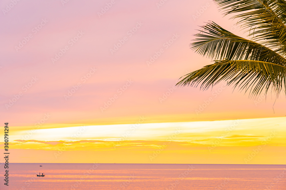 Beautiful sea ocean beach with palm tree at sunrise time for holiday