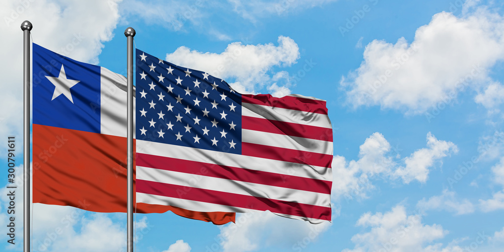 Chile and United States flag waving in the wind against white cloudy blue sky together. Diplomacy concept, international relations. Chile and United States flag waving in the wind against white cloudy blue sky together. Diplomacy concept, international relations.
