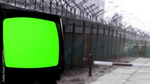 Retro TV with Green Screen and the Berlin Wall as a Background. You can replace green screen with the footage or picture you want. You can do it with “Keying” effect in After Effects. photo