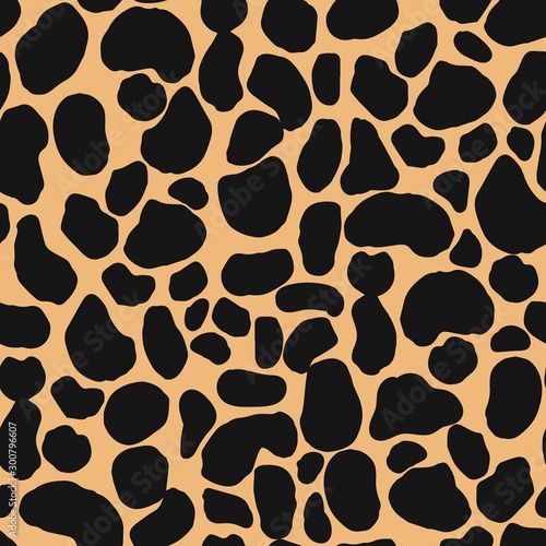 Seamless repeat pattern with abstract animal spots pattern in black and tan