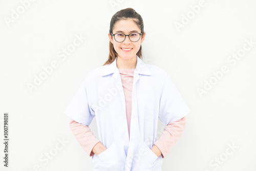 Portrait of young Asian woman wearing gown coat isolated on white wall background. Conceptual of woman staff who working in hospital or clinic.