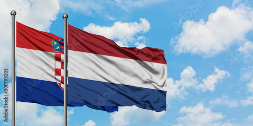 Croatia and Netherlands flag waving in the wind against white cloudy blue sky together. Diplomacy concept, international relations.