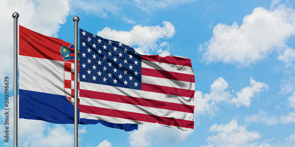 Croatia and United States flag waving in the wind against white cloudy blue sky together. Diplomacy concept, international relations. Croatia and United States flag waving in the wind against white cloudy blue sky together. Diplomacy concept, international relations.