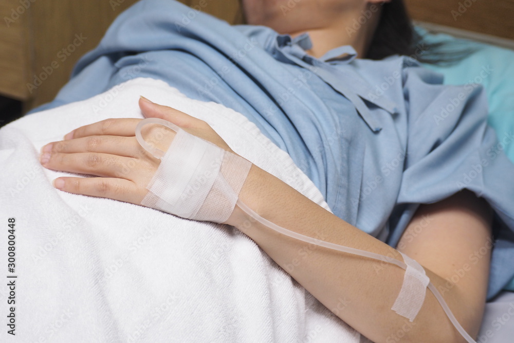 Fototapeta premium The hand of a patient with a saline solution.