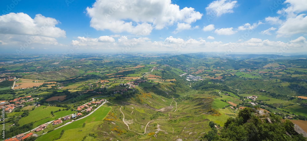 Panaramic areal view to hills, roads, green woods and houses from mountain Monte Titano, San-Marino