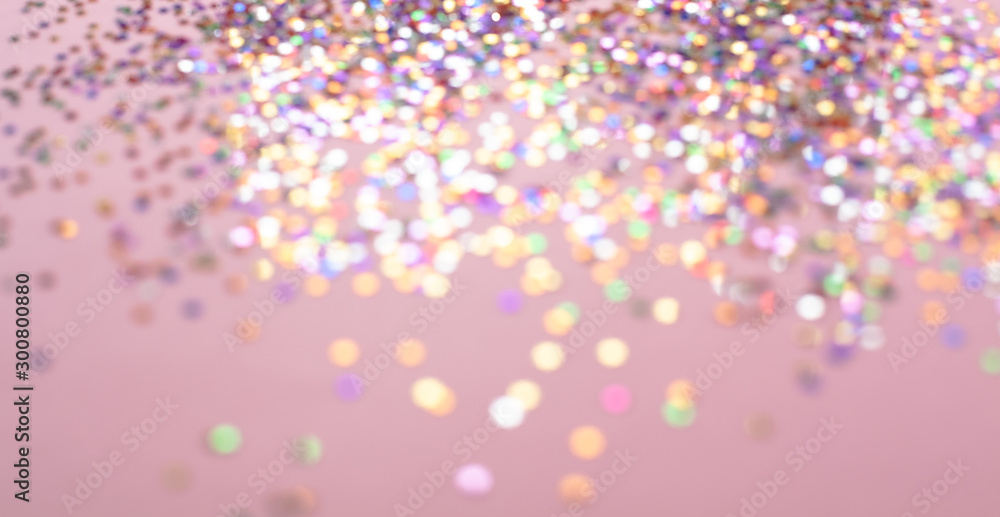 Bokeh background of abstract glitter lights. Pink gold and white. Defocused image
