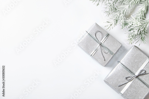 Silver gift box with ribbon and bow on white background.