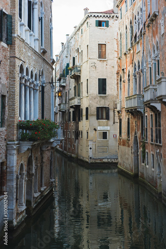 View of the canals and buildings of Venice. Beautiful historic brick buildings on the narrow streets and canals of the ancient city. Warm autumn day  travel to Italy.