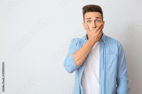 Surprised young man on ligh...