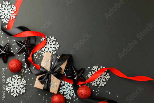 Silver snowflakes, gift box, christmas red balls and black stars on dark background, stylush luxury happy new year concept, xmas holiday present, sale, coupon idea photo