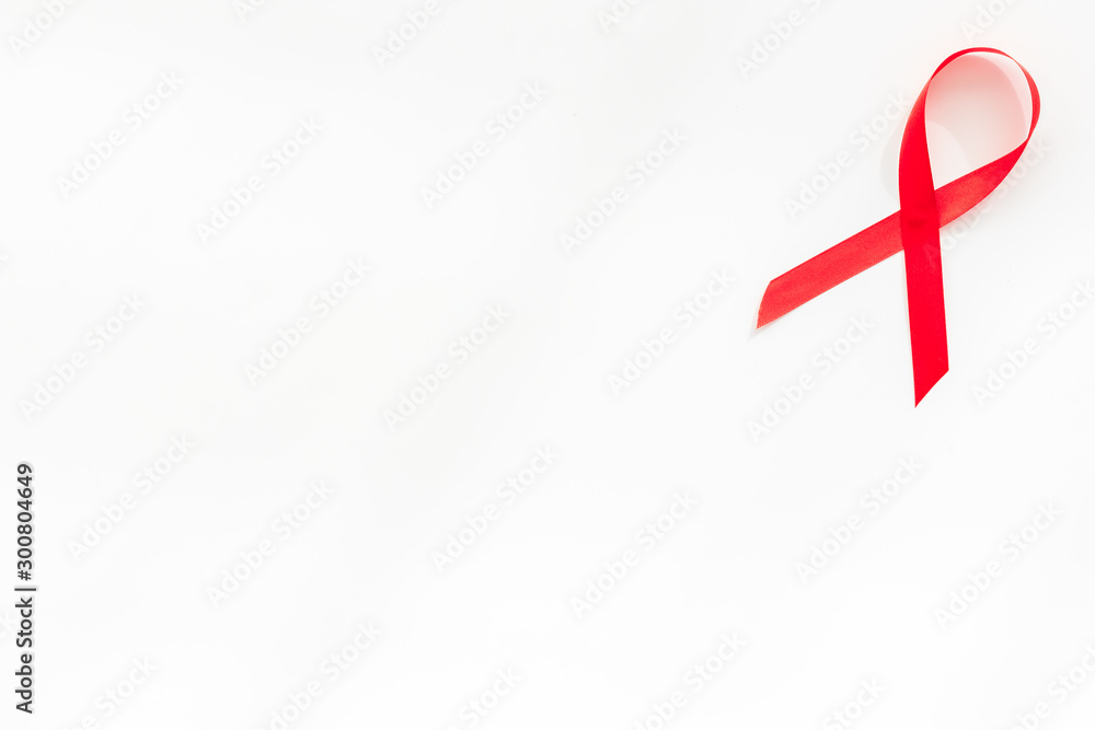 AIDS disease. Red ribbon on white background top view copy space AIDS disease. Red ribbon on white background top view copy space
