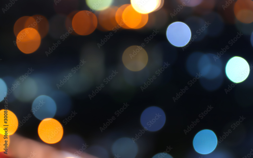 Abstract bokeh of city lights defocused on black background in various colors - obrazy, fototapety, plakaty 