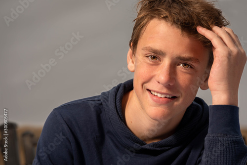 Close up portrait of a young man, smiling, relaxed.