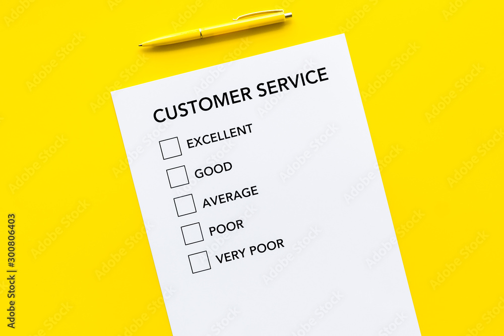 Customer service form with mark Exellent close up on yellow background top view space for text Customer service form with mark Exellent close up on yellow background top view space for text