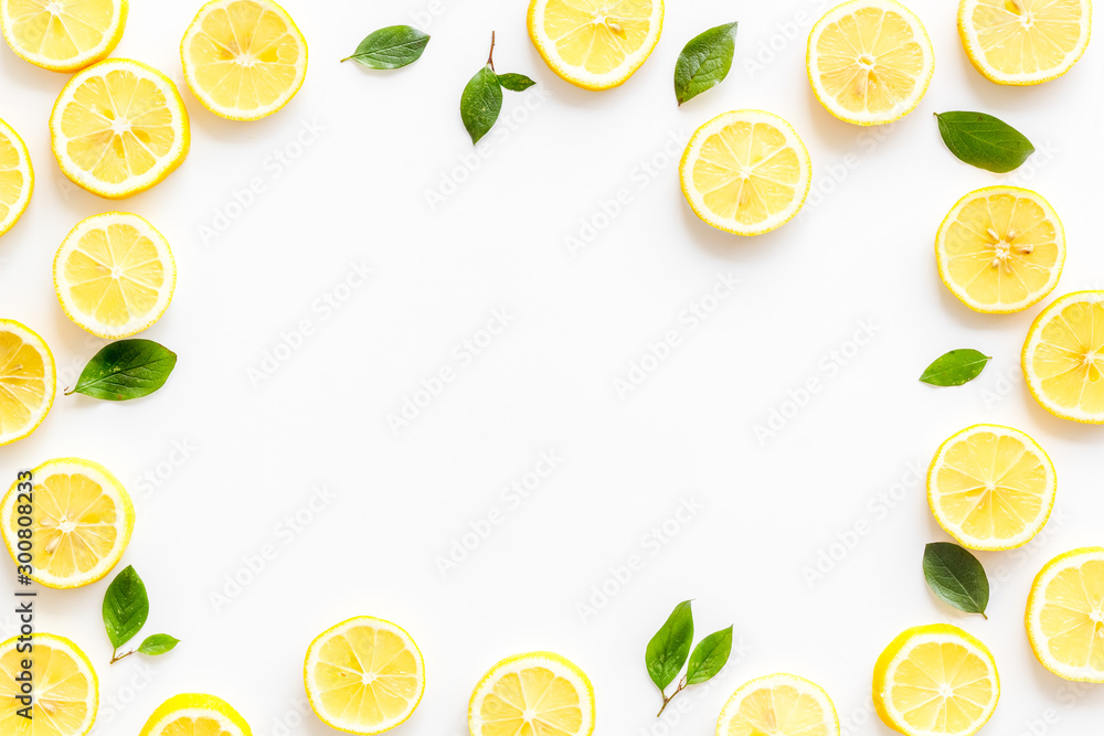 Fruit frame. Lemons and leaves on white background top view copy space