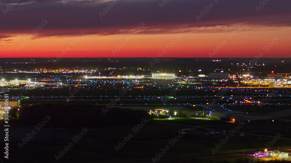 Detroit Michigan Aerial v174 Plane and car traffic focused airport cityscape at sunset dusk - October 2017 Detroit Michigan Aerial v174 Plane and car traffic focused airport cityscape at sunset dusk - October 2017