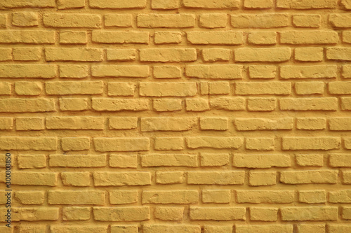 Old tuscany yellow colored brick wall for background and banner