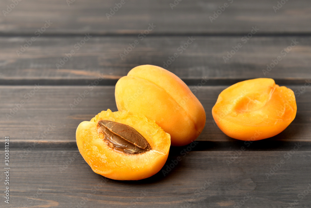 Juicy ripe apricot on a wooden desk