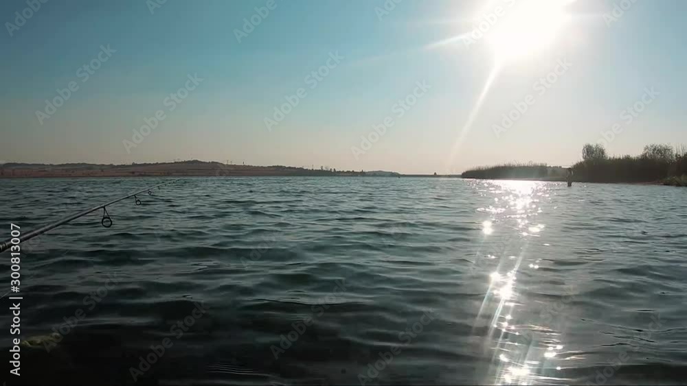 Fishing in a beautiful lake with the sun bouncing off the water at Rietvlei Dam, South Africa Fishing in a beautiful lake with the sun bouncing off the water at Rietvlei Dam, South Africa