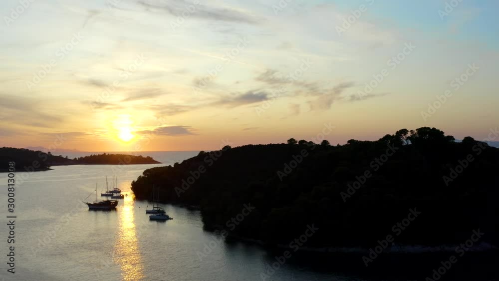 orange Sommer Sunset reflects in mediterranean Sea with sailing Ships at Pomena on Mljet Island in Croatia (aerial flight) orange Sommer Sunset reflects in mediterranean Sea with sailing Ships at Pomena on Mljet Island in Croatia (aerial flight)
