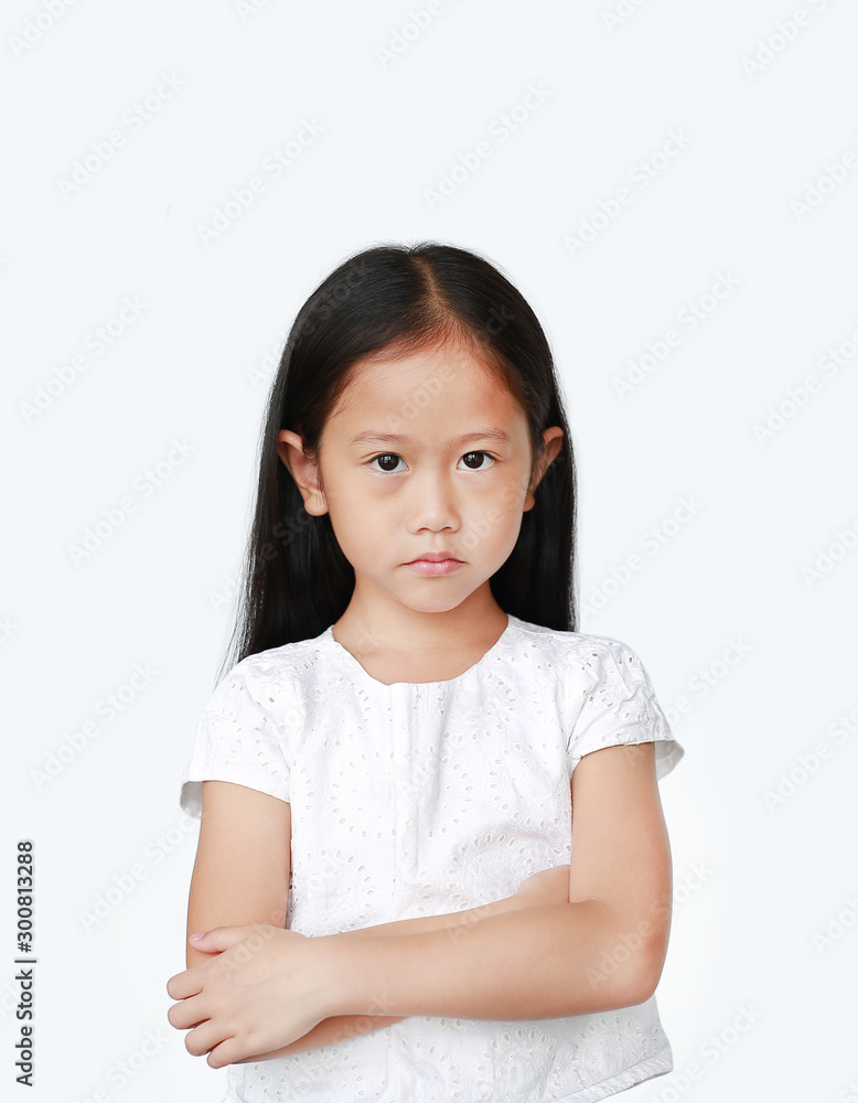 Cute little hispanic Asian child girl with arms crossed and angry about something over white background with looking at camera. Person with Negative emotion concept. Cute little hispanic Asian child girl with arms crossed and angry about something over white background with looking at camera. Person with Negative emotion concept.