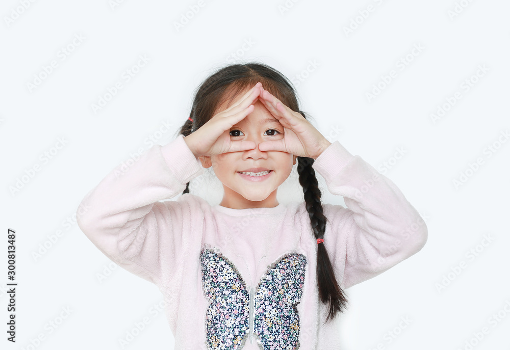 Happy little girl making triangle with looking through her hands isolated over white background. Happy little girl making triangle with looking through her hands isolated over white background.