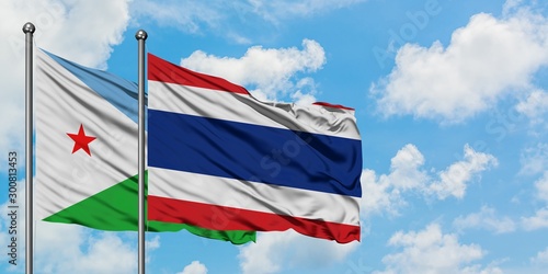 Djibouti and Thailand flag waving in the wind against white cloudy blue sky together. Diplomacy concept, international relations.