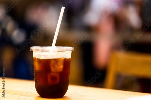 A black coffee on recycle glass and paper straw